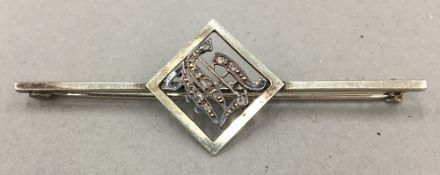 A diamond set unmarked bar brooch (3.