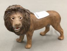 A cold painted bronze model of a lion