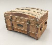 A 19th century French chocolate box formed as a miniature leather trunk