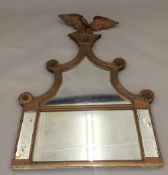 A 19th century gilt framed overmantle mirror surmounted with an eagle