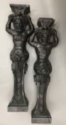 A pair of 19th century carved oak figural pedestals