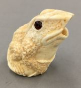A bone carving of a frog