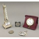 A mother-of-pearl thermometer, a travelling clock, a silver decanter label, etc.