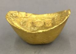 A Chinese gold coloured paperweight