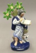 A late 18th/early 19th century Staffordshire figure of St Luke