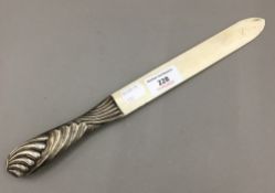 A silver handled letter opener