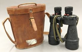 A pair of cased military binoculars