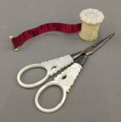 A Victorian turned bone and mother-of-pearl measuring tape,