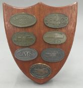 A shield mounted with various locomotive related badges