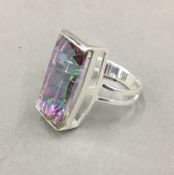 A silver multi coloured stone ring