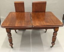 A Victorian mahogany two leaf extending dining table