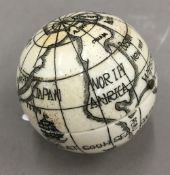 A bone globe compass