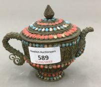 An Eastern tea pot set with coral and turquoise