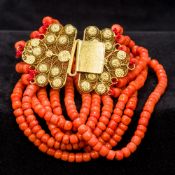 A six strand coral bead necklace Set with an 18 ct gold filigree clasp. Approximately 36 cm long.