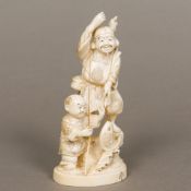 A 19th century Japanese carved ivory okimono Worked as a successful fisherman and his son, signed,