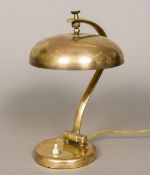 An early 20th century Continental brass desk lamp The umbrella shade supported on an adjustable arm,