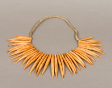 A tribal tooth necklace Each of varying sizes. The longest approximately 11 cm.