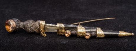 An unmarked gold mounted citrine set carved wooden brooch Formed as a dirk,