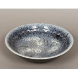 A Studio pottery bowl The interior with souffle glaze, impressed mark GA to base. 39.5 cm diameter.