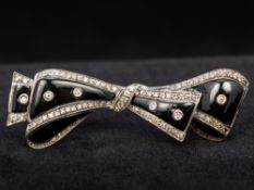 An 18 ct white gold diamond and enamel bar brooch Formed as a tied bow. 5.75 cm wide.