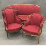 A matched 19th century carved giltwood framed upholstered three piece suite,