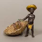 A Chinese cold painted bronze model formed as a young fisher boy holding a fish beside a basket