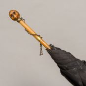 An Edwardian parasol by Brigg of London With monkey mask carved finial and inscribed Hon.