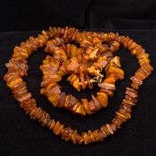 Two uncut and unpolished amber bead necklaces Approximately 45 cm and 68 cm long.