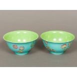 A pair of Chinese porcelain bowls Each interior with a plain green glaze,