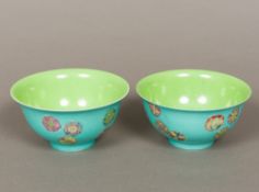 A pair of Chinese porcelain bowls Each interior with a plain green glaze,