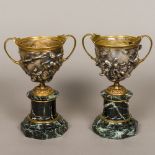 A pair of 19th century silvered and gilt bronze classical urns Each of twin handled form,