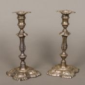 A pair of Edwardian silver candlesticks, one marked for London 1907, the other London 1908,