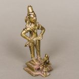 An antique Indian bronze figural group Modelled as a figure kneeling before a deity. 16 cm high.
