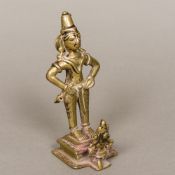 An antique Indian bronze figural group Modelled as a figure kneeling before a deity. 16 cm high.