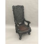 A late 19th/early 20th century Chinese carved hardwood open armchair The panelled back centred with