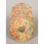 A Chinese carved russet jade bi disc The typical carved roundel beneath pierced carved dragons. 31.