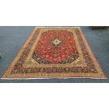 A Kashan wool carpet The wine red field with central medallion with pendant palmettes within