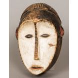 An African tribal carved wooden mask With original lime pigment decoration. 29 cm high.
