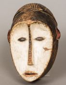 An African tribal carved wooden mask With original lime pigment decoration. 29 cm high.