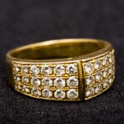 An unmarked gold and diamond ring Set with three rows of graduating diamonds. 8mm high.