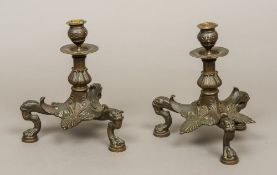 A pair of French Napoleon III bronze candle stands The urn shaped socles supported on an anthemion