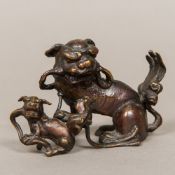 A Chinese patinated bronze group, possibly 18th century Modelled as two dogs-of-fo. 13 cm wide.