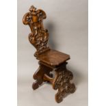 A 19th century carved walnut Sgabello chair The shaped back worked with a vacant heraldic shield,