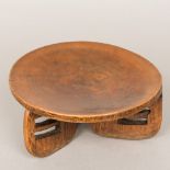 An African tribal Kamba People of Kenya carved wooden stool Of low concave form with three pierced