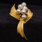 A pearl and diamond set 750 gold brooch Worked as a fruiting spray. 5.5 cm wide.