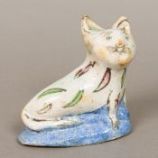 A Persian pottery model of a cat Modelled seated. 13.5 cm wide.