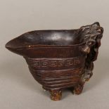 An 18th/19th century Chinese carved wood libation cup Of typical form with pierced handle,