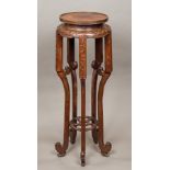 A 19th century Chinese carved hardwood urn stand The dished circular top above the carved frieze,