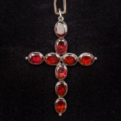 A Georgian unmarked white metal garnet set cross form pendant Mounted on a later silver chain.