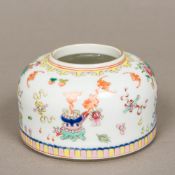 A Chinese porcelain brush wash Of beehive form, brightly decorated with precious objects,